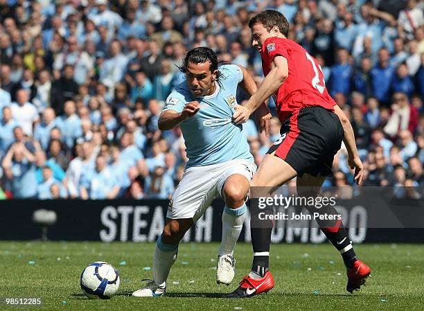 Jonny Evans of Manchester United clashes with Carlos Tevez of Manchester City during the Barclays Premier League match between Manchester City and...