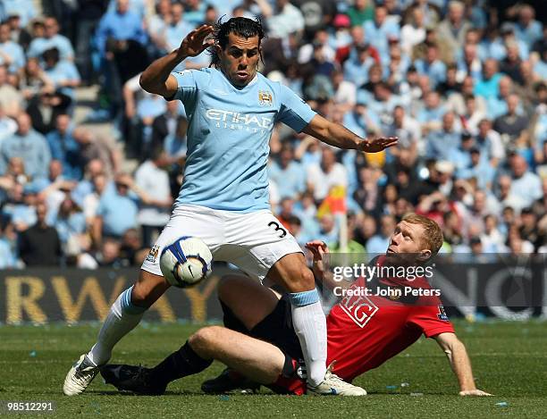 Paul Scholes of Manchester United clashes with Carlos Tevez of Manchester City during the Barclays Premier League match between Manchester City and...