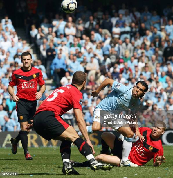 Paul Scholes of Manchester United clashes with Carlos Tevez of Manchester City during the Barclays Premier League match between Manchester City and...