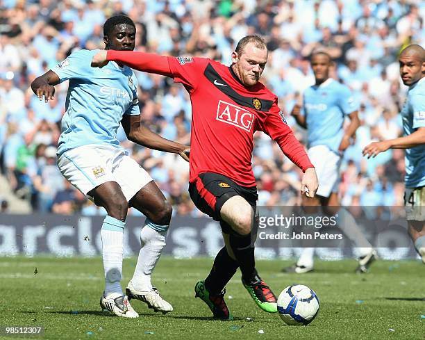 Wayne Rooney of Manchester United clashes with Kolo Toure of Manchester City during the Barclays Premier League match between Manchester City and...