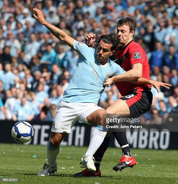 Jonny Evans of Manchester United clashes with Carlos Tevez of Manchester City during the Barclays Premier League match between Manchester City and...