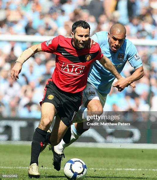 Ryan Giggs of Manchester United clashes with Nigel De Jong of Manchester City during the Barclays Premier League match between Manchester City and...