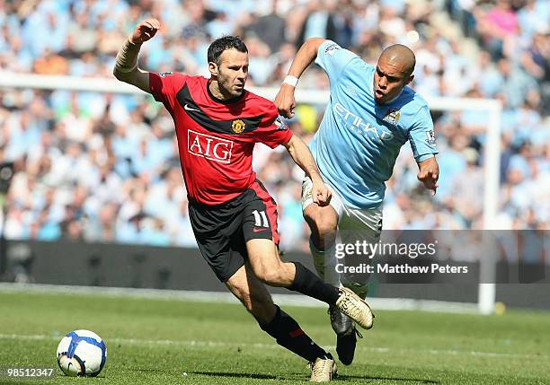 Ryan Giggs of Manchester United clashes with Nigel De Jong of Manchester City during the Barclays Premier League match between Manchester City and...