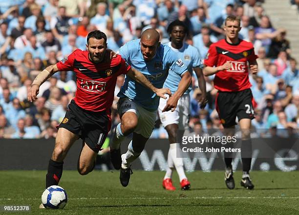 Ryan Giggs of Manchester United clashes with Nigel De Jong of Manchester City during the Barclays Premier League match between Manchester City and...
