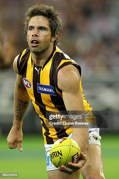 Chance Bateman of the Hawks handballs during the round four AFL match between the Collingwood Magpies and the Hawthorn Hawks at Melbourne Cricket...