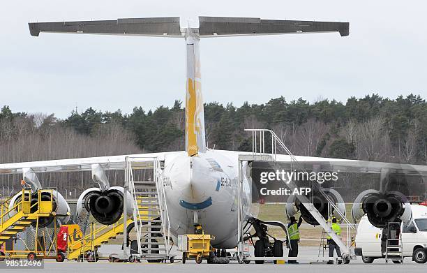 Technicians work on the engines of one of Malmo Aviation's RJ85 aircrafts parked at Bromma airport in Stockholm on April 17, 2010. Millions of people...