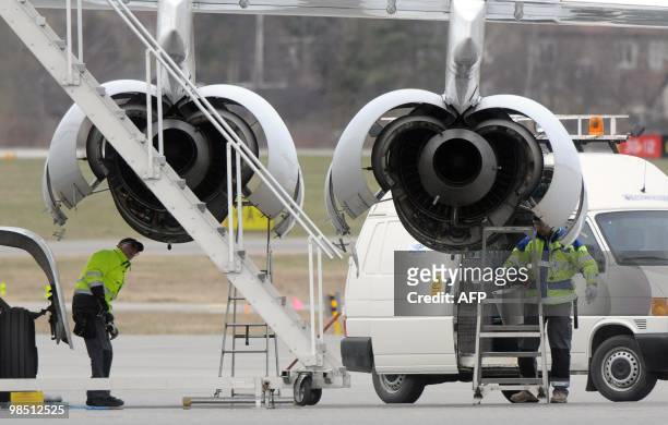 Technicians work on the engines of a Malmo Aviation�s RJ85 aircraft parked at Bromma airport in Stockholm on April 17, 2010. Millions of people faced...