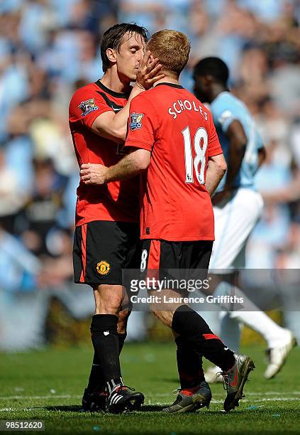 Paul Scholes of Manchester United is kissed by team mate Gary Neville after scoring the winning goal during the Barclays Premier League match between...