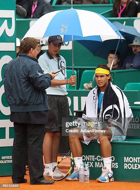 Rafael Nadal of Spain waits for the rain to stop before his match against David Ferrer of Spain during day six of the ATP Masters Series at the Monte...