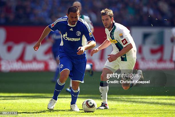Thorben Marx of Gladbach challenges Edu of Schalke during the Bundesliga match between FC Schalke 04 and Borussia Moenchengladbach at the Veltins...