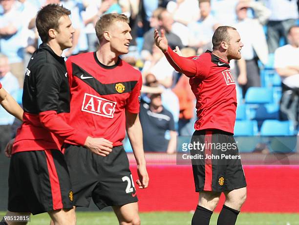 Michael Carrick, Darren Fletcher and Wayne Rooney of Manchester United celebrate after the Barclays Premier League match between Manchester City and...