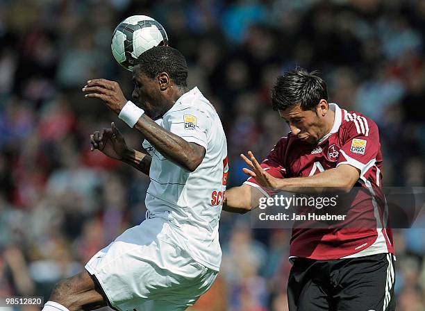 Mohamadou Idrissou of Freiburg and Dominic Maroh of Nuernberg jump for a header during the Bundesliga match between SC Freiburg and 1.FC Nuernberg at...