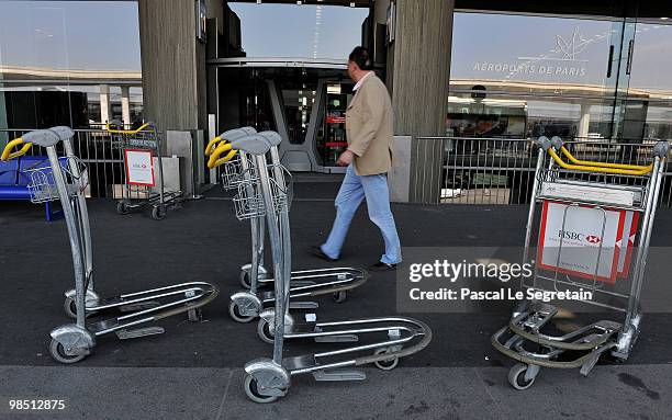 Passenger walks outside Roissy Charles-de-Gaulle terminal E after airports including Charles de Gaulle and Orly were closed while wind continues to...