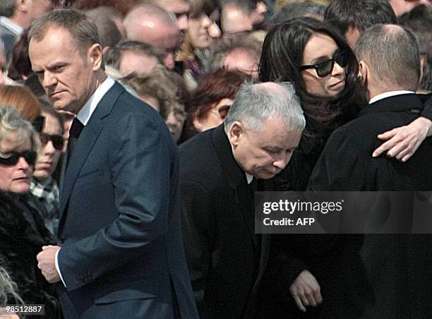 Late Polish President Lech Kaczynski's daughter Marta hugs Maciej Lopinski, Director of the Presidential cabinet next to her uncle Jaroslaw Kaczynski...