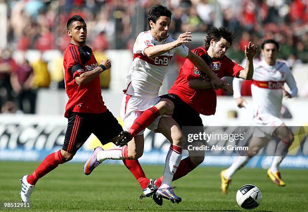 Ciprian Marica of Stuttgart is challenged by Arturo Vidal and Tranquillo Barnetta of Leverkusen during the Bundesliga match between VfB Stuttgart and...