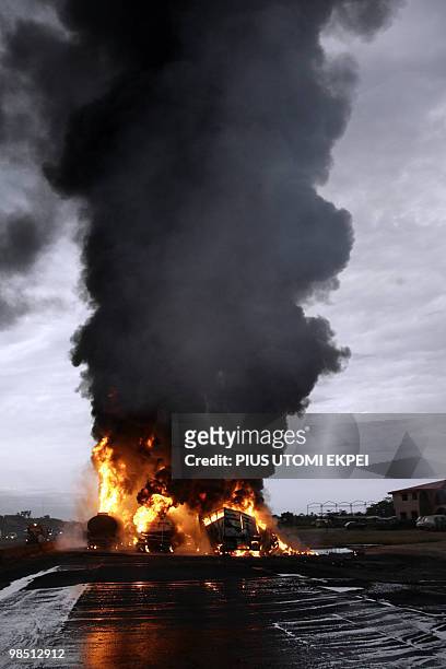 Flames roar from the collision of two tankers filled with petrol and three trucks carrying goods, on Lagos Ibadan Highway in Ibafo in the early hours...