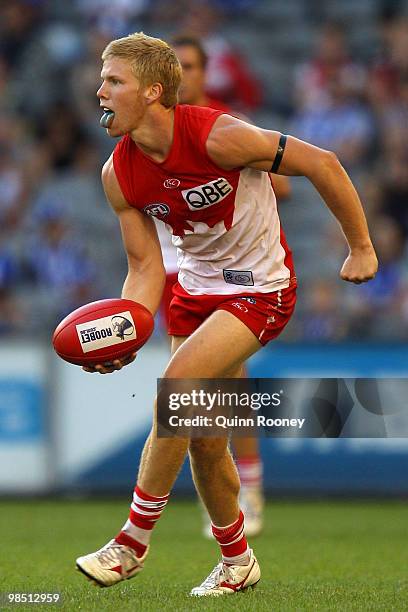 Daniel Hannebery of the Swans handballs during the round four AFL match between the North Melbourne Kangaroos and the Sydney Swans at Etihad Stadium...
