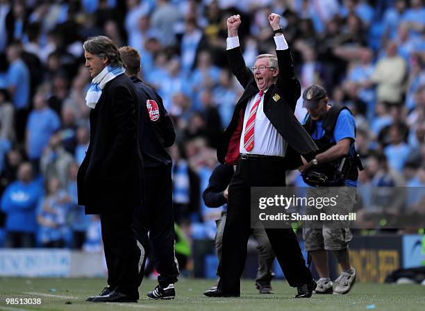 Manchester United Manager Sir Alex Ferguson celebrates as Manchester City Manager Roberto Mancini looks on during the Barclays Premier League match...