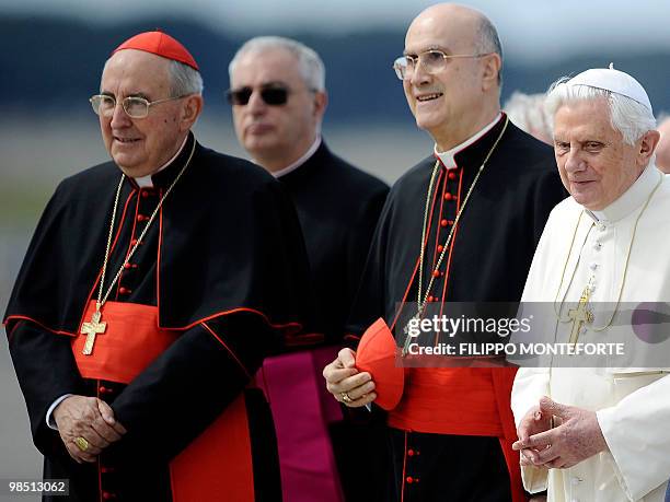 Pope Benedict XVI is flanked by Vatican Secretary of State Cardinal Tarcisio Bertone as he arrives to board a plane for Malta on April 17, 2010 at...