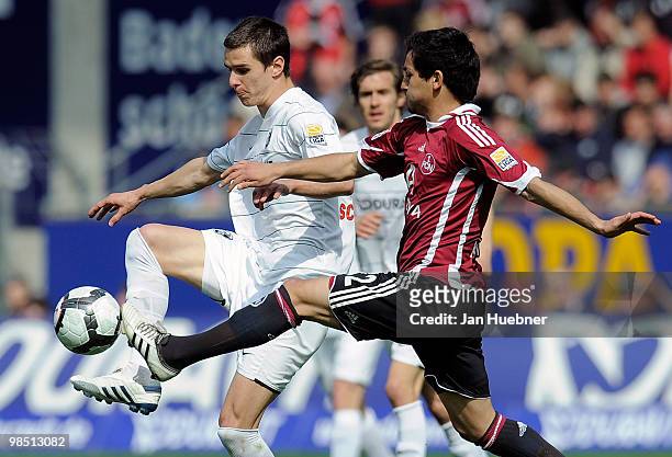 Johannes Flum of Freiburg battles for the ball with Ilkay Guendogan of Nuernberg during the Bundesliga match between SC Freiburg and 1.FC Nuernberg...