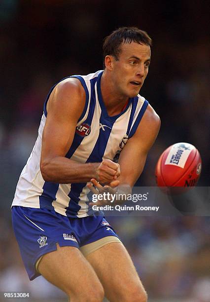 David Hale of the Kangaroos handballs during the round four AFL match between the North Melbourne Kangaroos and the Sydney Swans at Etihad Stadium on...