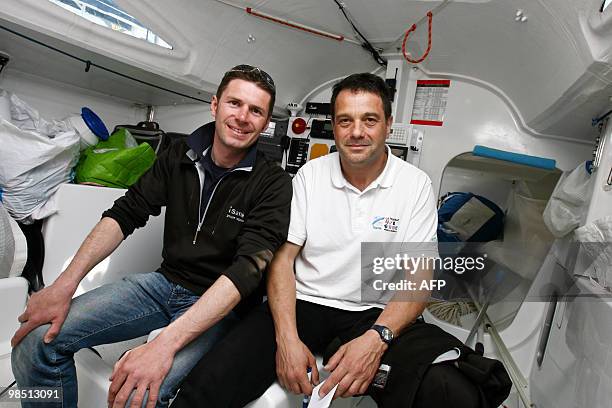 French skippers Sylvain Pontu and Christophe Rateau pose in the cabin of their monohull "iSanté", on April 17, 2010 in Concarneau, western France,...