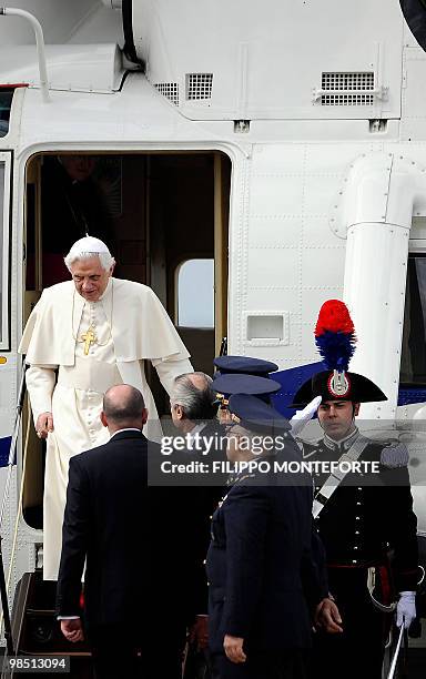 Pope Benedict XVI leaves his helicopter as he arrives to board a plane for Malta on April 17, 2010 at Fiumicino airport near Rome. Pope Benedict XVI...