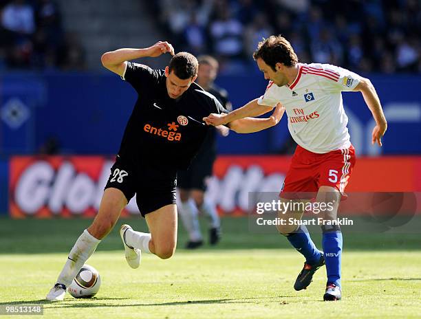 Adam Szalai of Mainz is challenged by Joris Mathijsen of Hamburg during the Bundesliga match between Hamburger SV and FSV Mainz 05 at HSH Nordbank...