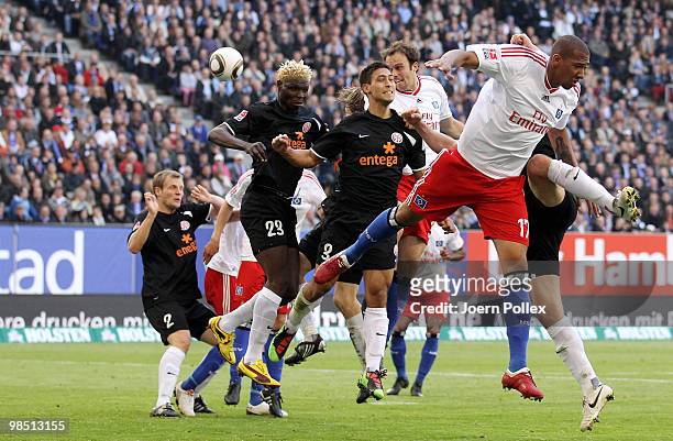 Joris Mathijsen of Hamburg as well as Aristide Bance and Malik Fathi of Mainz and Jerome Boateng of Hamburg compete for the ball during the...