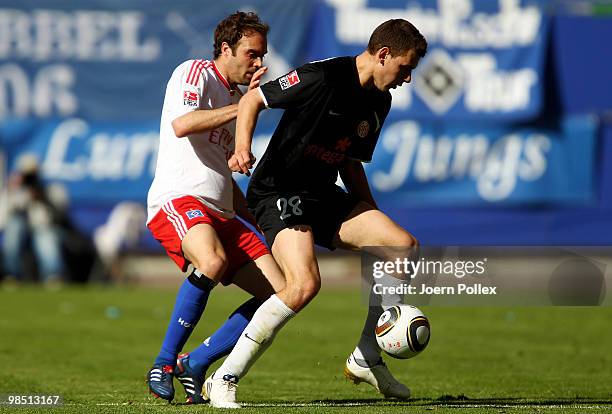 Joris Mathijsen of Hamburg and Adam Szalai of Mainz compete for the ball during the Bundesliga match between Hamburger SV and FSV Mainz 05 at HSH...