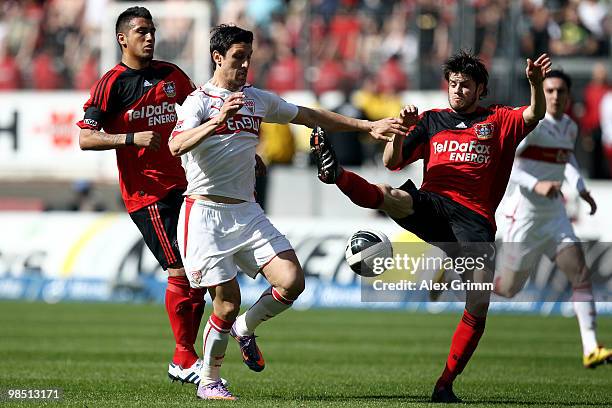 Ciprian Marica of Stuttgart is challenged by Arturo Vidal and Tranquillo Barnetta of Leverkusen during the Bundesliga match between VfB Stuttgart and...