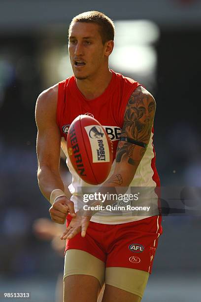 Jesse White of the Swans handballs during the round four AFL match between the North Melbourne Kangaroos and the Sydney Swans at Etihad Stadium on...