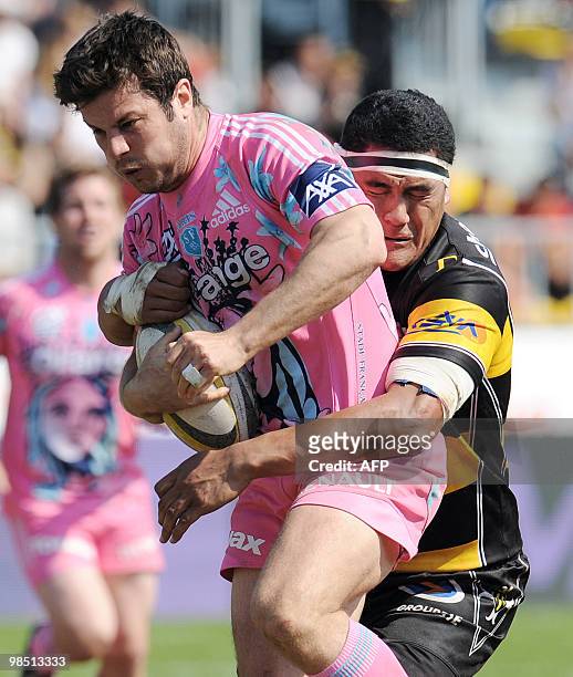 Stade Francais's fullback Hugo Southwell is tackled by Albi's player Daniel Farani during the French Top 14 rugby union match Albi vs. Stade Francais...
