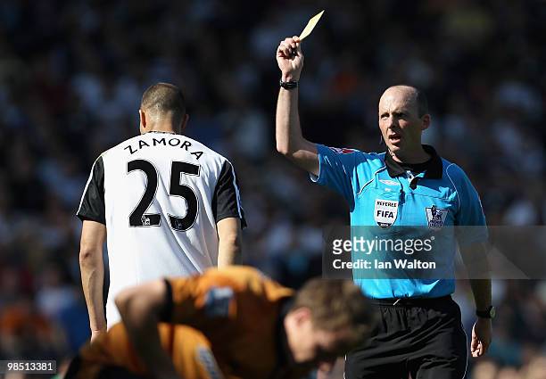 Bobby Zamora of Fulham is shown the yellow card by referee Mike Dean during the Barclays Premier League match between Fulham and Wolverhampton...