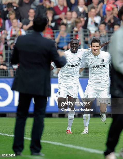 Head Coach Robin Dutt, Papiss Demba Cisse and Mensur Mujdza of Freiburg celebrate their second goal during the Bundesliga match between SC Freiburg...