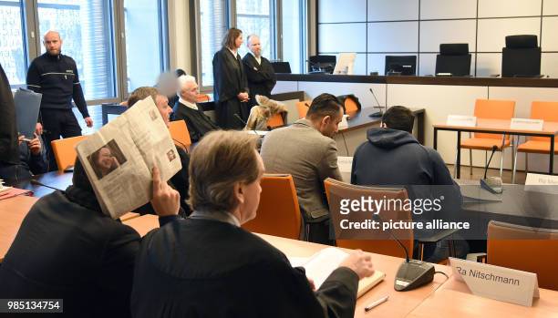 The eldest son, one of the defendants , a translator , lawyer Martin Nitschmann and another defendant wait with other participants at the district...