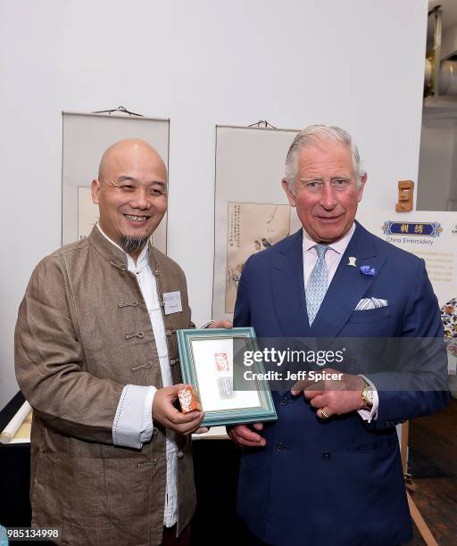 Prince Charles, Prince of Wales poses with artist Lizhong Wei as he attends The Prince's Foundation School of Traditional Arts degree show in...