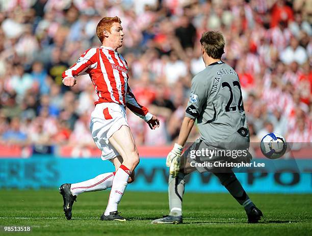 Dave Kitson of Stoke takes the ball past Jussi Jaaskelainen of Bolton to score their first goal during the Barclays Premier League match between...