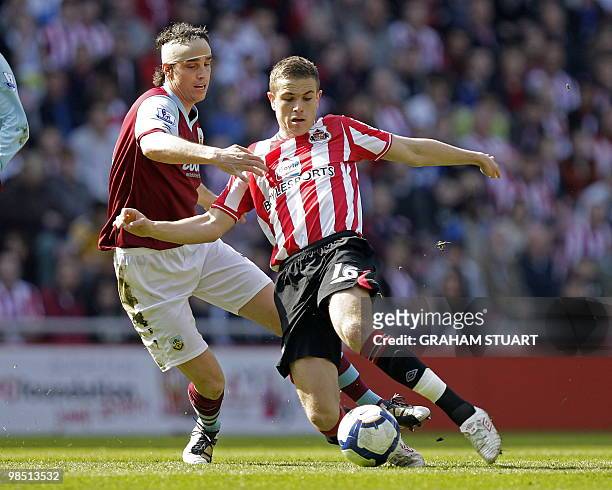 Sunderland's English midfielder Jordan Henderson vies with Burnley's Northern Irish defender Michael Duff during the English Premier League football...