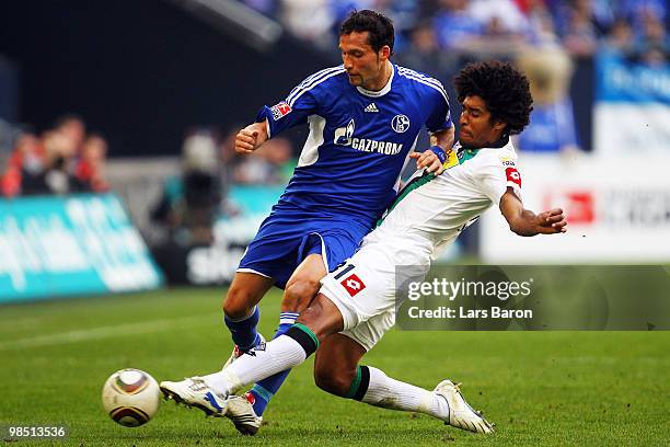 Kevin Kuranyi of Schalke is challenged by Dante of Moenchengladbach during the Bundesliga match between FC Schalke 04 and Borussia Moenchengladbach...