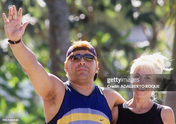 Ex-Argentine soccer player Diego Armando Maradona , with his wife Claudia Villafane, waves to the press 22 January 2000 in Havana, as they go for a...