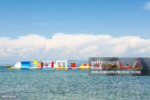 inflatable rubber water fun park in corfu / greece - water park stock pictures, royalty-free photos & images