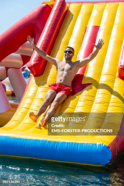 inflatable rubber water fun park in corfu / greece - shorts down stock pictures, royalty-free photos & images