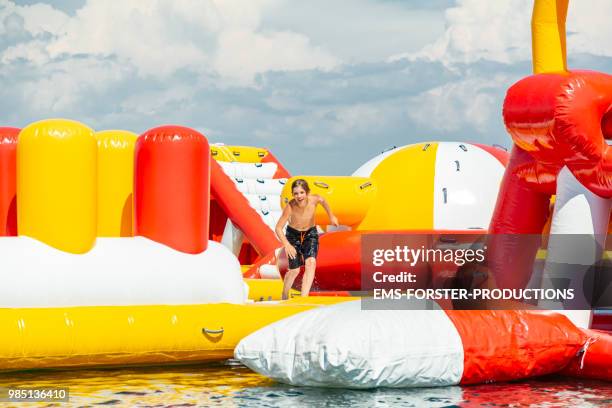 inflatable rubber water fun park in corfu / greece - ems forster productions stock pictures, royalty-free photos & images