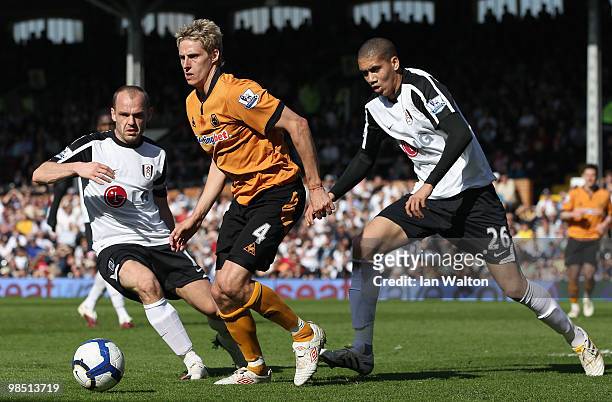 David Edwards of Wolves is closed down by Danny Murphy and Chris Smalling of Fulham during the Barclays Premier League match between Fulham and...