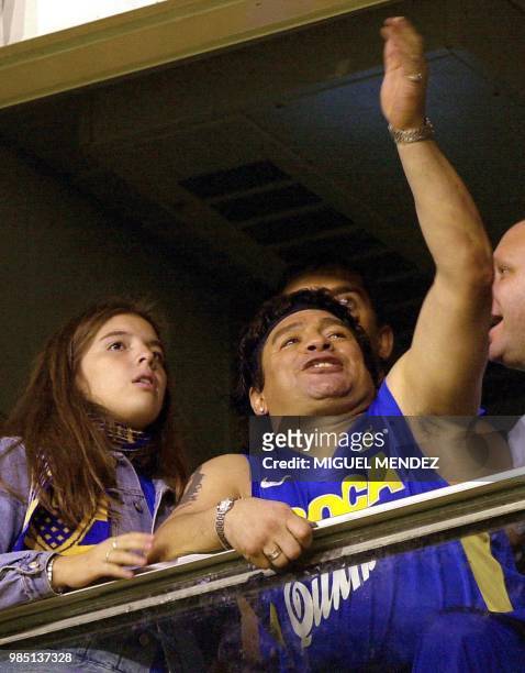 Accompanied by his daughter Dalma, Argentinian soccer star Diego Maradona watches the final match of the Copa Libertadores de America tournament...