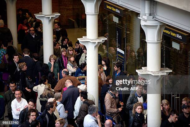 Travellers queue for Eurostar tickets at Kings Cross St Pancras railway station in central London on April 17, 2010. Nearly 17,000 flights in...