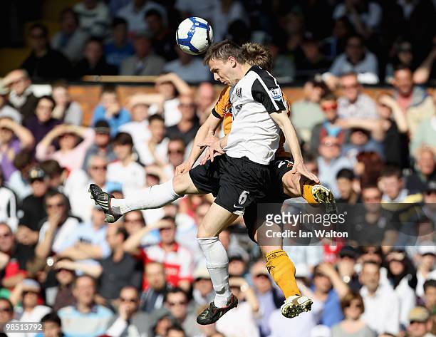 Chris Baird of Fulham and Kevin Doyle of Wolves jump for the ball during the Barclays Premier League match between Fulham and Wolverhampton Wanderers...