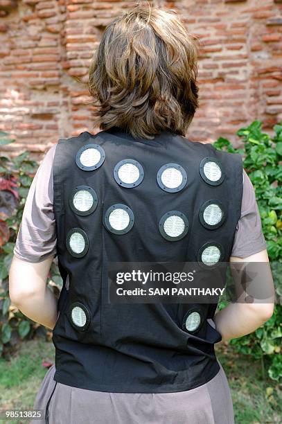 Dhama Apparel Innovations industrial designer Julianne Gauron displays the back of a "ClimaGear" air conditioned vest at the National Institute of...