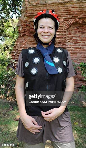Dhama Apparel Innovations industrial designer Julianne Gauron displays the air conditioned "ClimaGear" vest, "ClimaNeck" scarf and "Climamet" helmet...